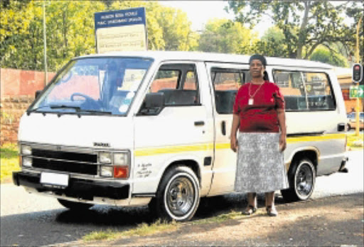 SATISFIED: Geqezile Ntombela stands next to her Toyota Siyaya.