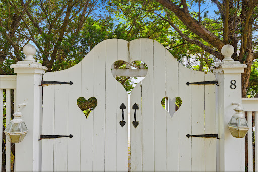 White gate with cut-out hearts in this luxury property for sale in Haddam ($1,095,000)
