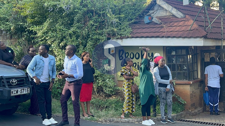 Friends and colleagues outisde the late journalist Rita Tinina's apartment in Kileleshwa, Nairobi on March 17, 2024