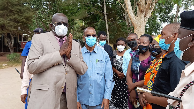 Education CS George Magoha with Kwale Deaf High teachers and county officials when he visited the school to commission a completed CBC classroom block on March 3, 2022.