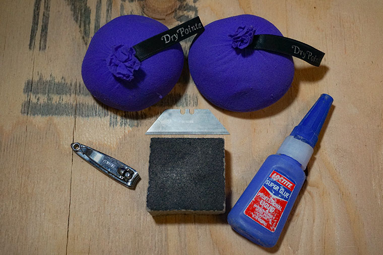 Shoe care kit: DryPointe shoe inserts, a razor blade, nail clippers, superglue, and a sanding sponge