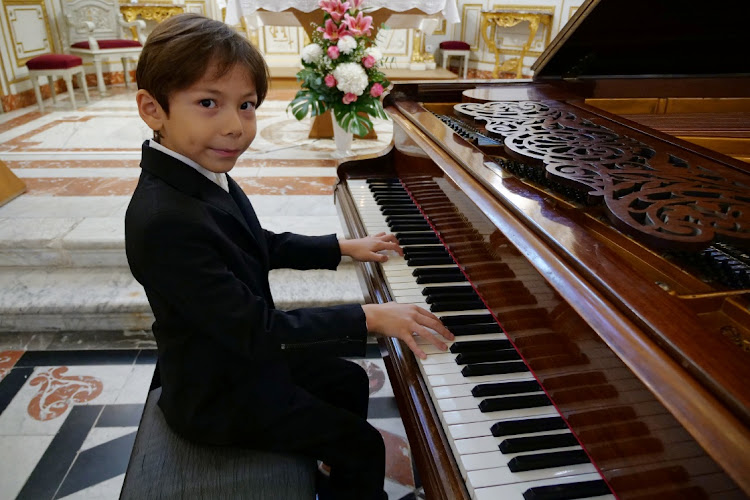 Guillaume Benoliel, a six-year-old child, plays the piano during a practice session in a church in Brunoy, France, on October 5, 2020.