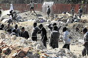 Pupils from Paradise Bend Primary School in Diepsloot at a dumping ground beside their playground. It is suspected that companies are disposing of waste in the area illegally