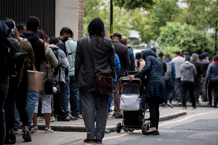 Immigrants queue around the government Home Office building of Becket House on August 2, 2017 in London, England. Becket House is an Immigration Enforcement Reporting Centre where asylum seekers have to 'sign on' on a regular basis.