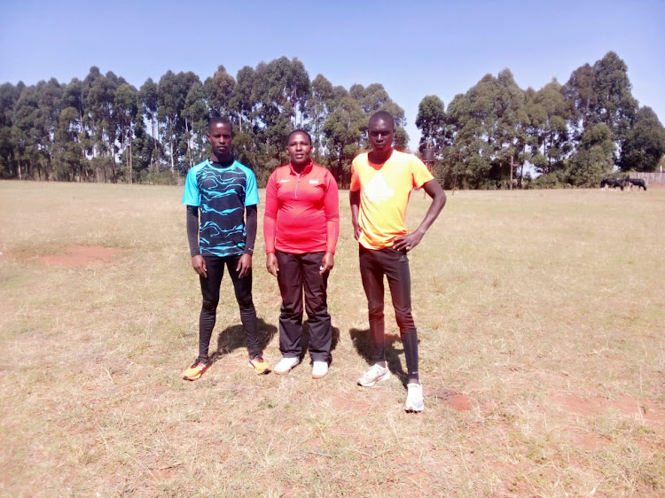 Dennis Ruto (L) and Dennis Kipruto (R) with Kapkoimur Training camp, Kapkoimur Athletics Training Camp chaperon Ruth Keter (C).