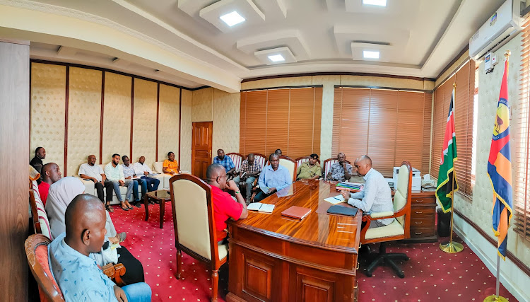 Garissa County Secretary Mohamud Mursal with officials from LAPSSET who paid a courtesy call in his office.