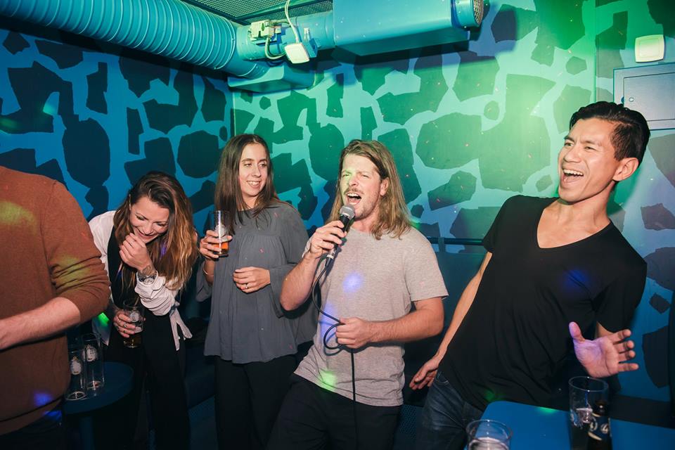 people singing karaoke in singa's karaoke room