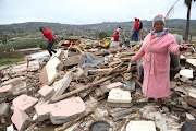 Granny Bongi Nxumalo stands at what remains of the Pietermaritzburg house that her son and four grandchildren lived in. The house was flattened by a truck on Friday morning while the children were inside. PICTURE: JACKIE CLAUSEN.