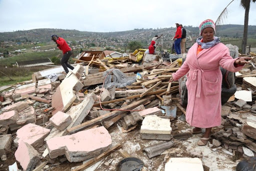 Granny Bongi Nxumalo stands at what remains of the Pietermaritzburg house that her son and four grandchildren lived in. The house was flattened by a truck on Friday morning while the children were inside. PICTURE: JACKIE CLAUSEN.