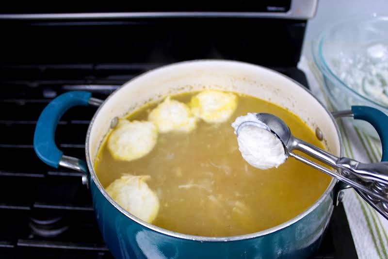 Scooping Dumpling Batter Into Soup.