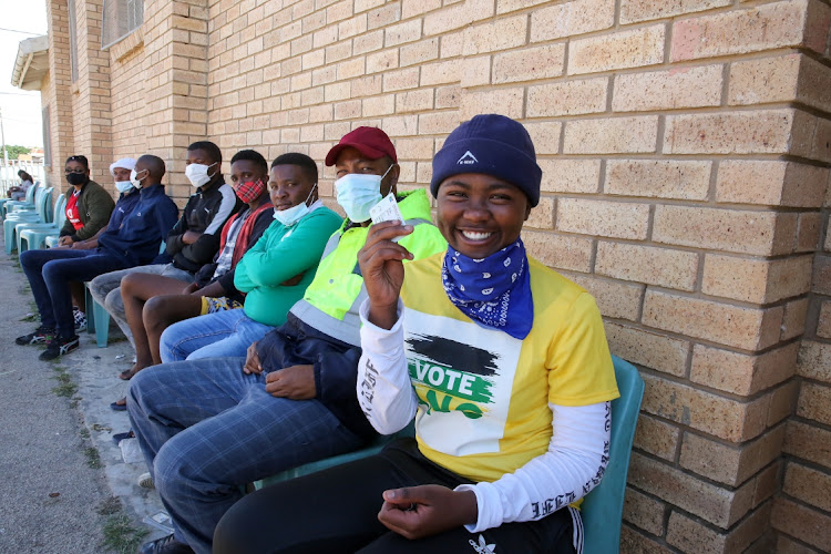 First-time voter Sinoxolo Dayimami, 18, queues to cast her vote in the local government elections at Kwamagaxi High School in Gqeberha.