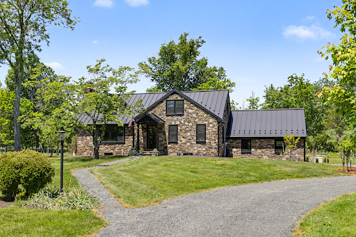 Stone house with grey roof in this luxury property for sale in New Hope ($1,295,000)