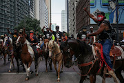 Protesters on horseback rally against the death in Minneapolis police custody of George Floyd, through downtown Houston, Texas, U.S., June 2, 2020. 