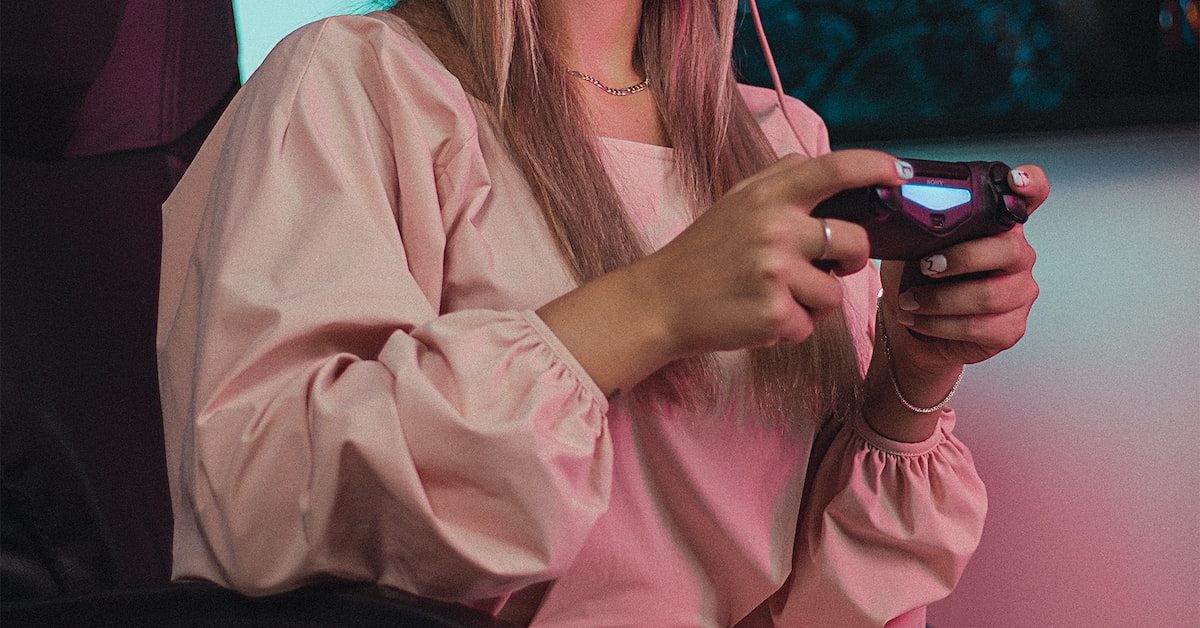 A girl with a controller in her hands plays a game