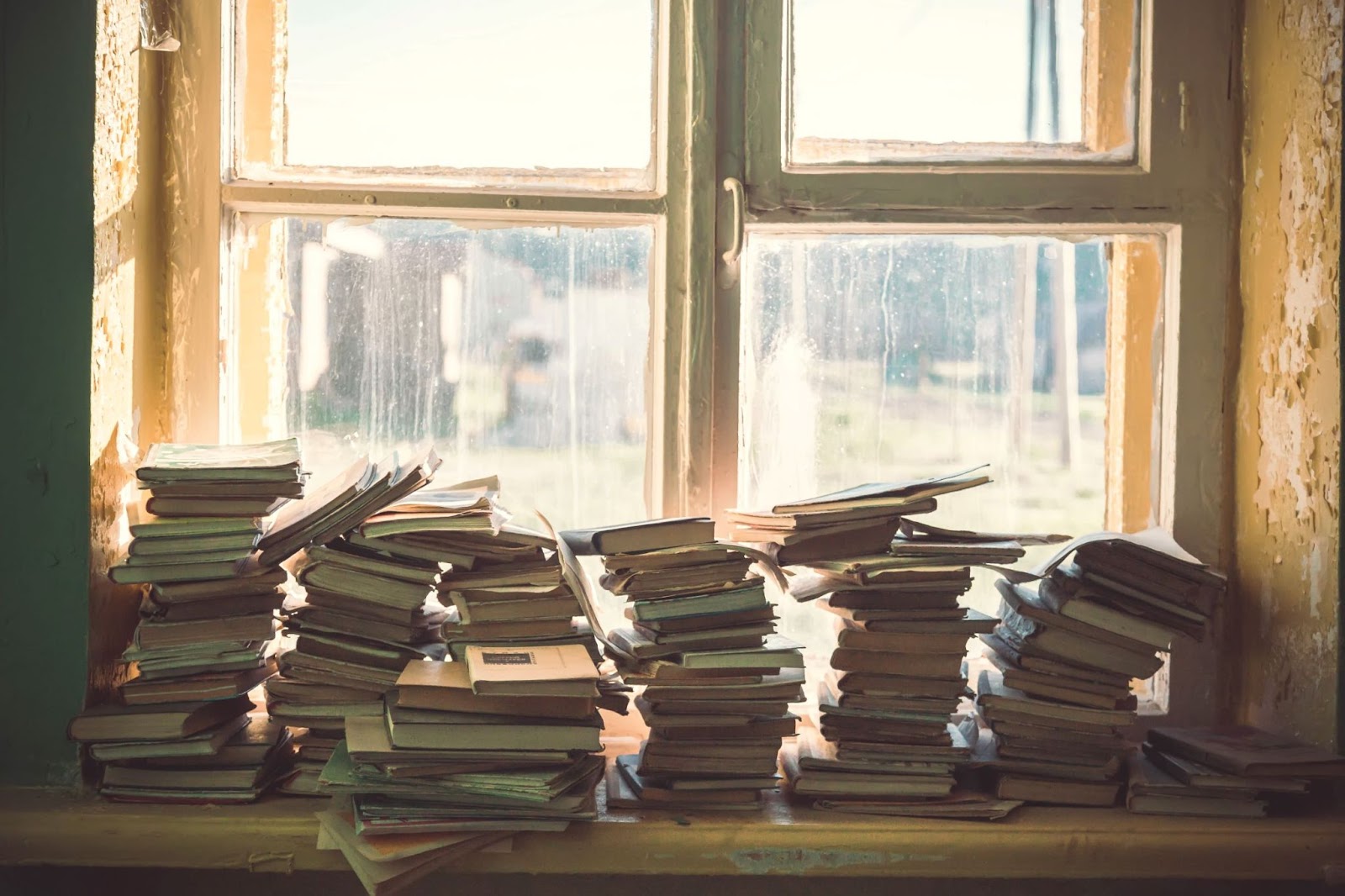 stacks-of-books-by-window