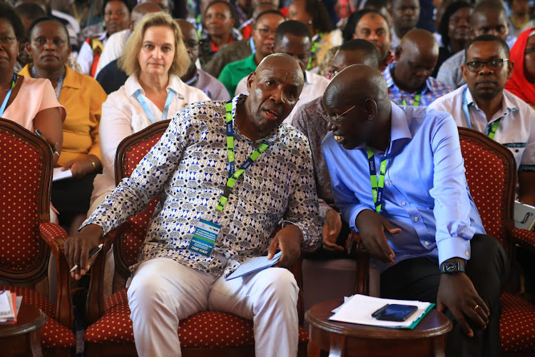 Education CS Ezekiel Machogu and Basic Education PS Belio Kipsang at the Sheikh Zayed Hall in Mombasa on Wednesday.