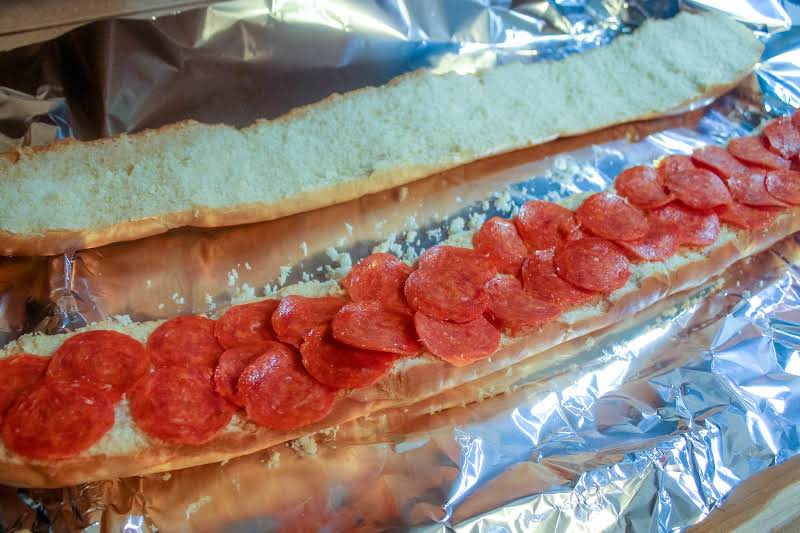 Bread On A Foil-lined Sheet With Pepperoni.