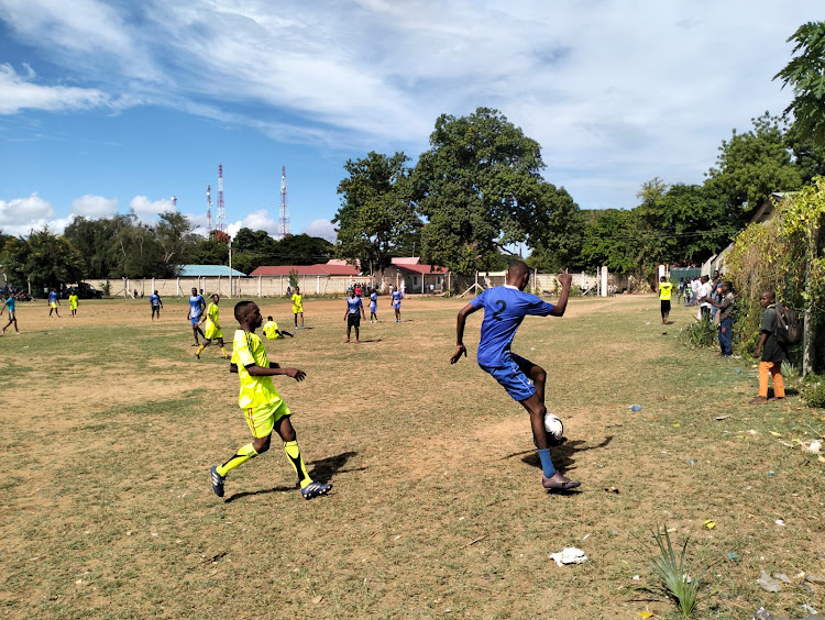 Lamu youth and Police Officers partake in a peace walk at Witu Town in Lamu West as part of efforts in the fight against radicalization, and violent extremism.The youth are in yellow jerseys while police officers are in blue /Cheti Praxides