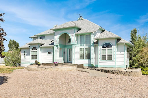 White house with green accents in this luxury house for sale in Polson ($3,395,000 - 478 m²)