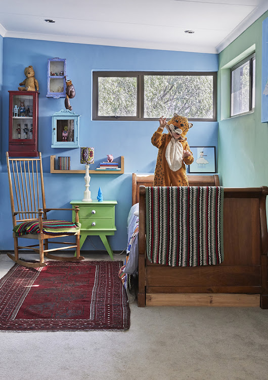 Felix and Hugo’s bedroom is painted in shades of blue and green.