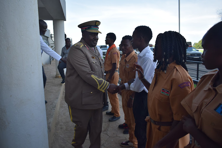 Homa Bay county commissioner Moses Lilan greets scouts during Jamhuri Day celebrations at Raila Odinga stadium in Homa Bay town on December 12,2023