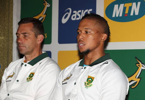 Springboks assistant coach Franco Smith (L) listens carefully alongside Elton Jantjies (R) during the South African national men's rugby team media briefing at Garden Court Umhlanga on June 13, 2017 in Durban, South Africa.