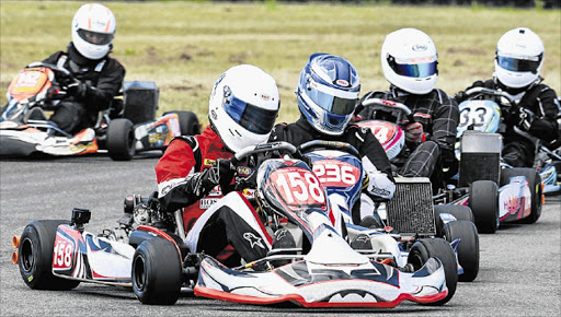 FIERCE RIVALRY: Border Karters race around the track during the second round of the Border Karting Champs at the East London Grand Prix Track. Picture: SUPPLIED