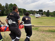 Paramedics race a critically injured man to a rescue helicopter on Wednesday after a blast at a car dealership in Bramley‚ Johannesburg.