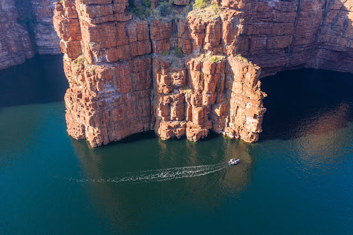 The cliff face in Australia’s Kimberley region dwarfs a Ponant Zodiac boat. 