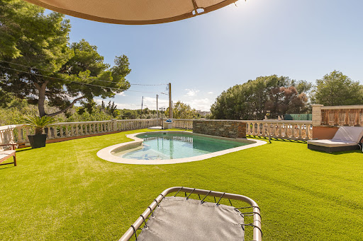 Outdoor swimming pool and landscaped garden in this luxury property for sale in Sant Pere de Ribes ($1,157,343)