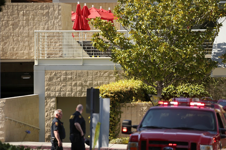 Law enforcement officers are seen near a patio with crime scene markers at Youtube headquarters following an active shooter situation in San Bruno, California Picture: Reuters/Elijah Nouvelage