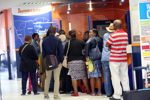 Stranded commuters queue at the counter at the Intercape Office in Durban to find out whether they will be able to catch their busses or if they can get a refund after some busses went on strike on Wednesday.