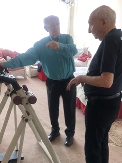 Barney Gordon, 98, shows friend Solly Krok, 92, how he keeps fit on his walking machine.