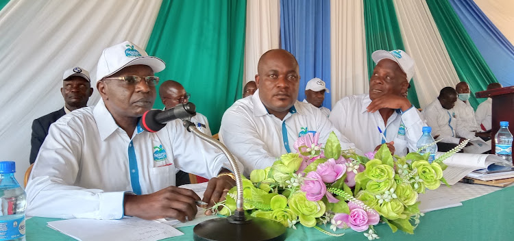 Ng'arisha Sacco board chairman Benedict Simiyu and CEO Mackline Wamukota in Busia town at the weekend.