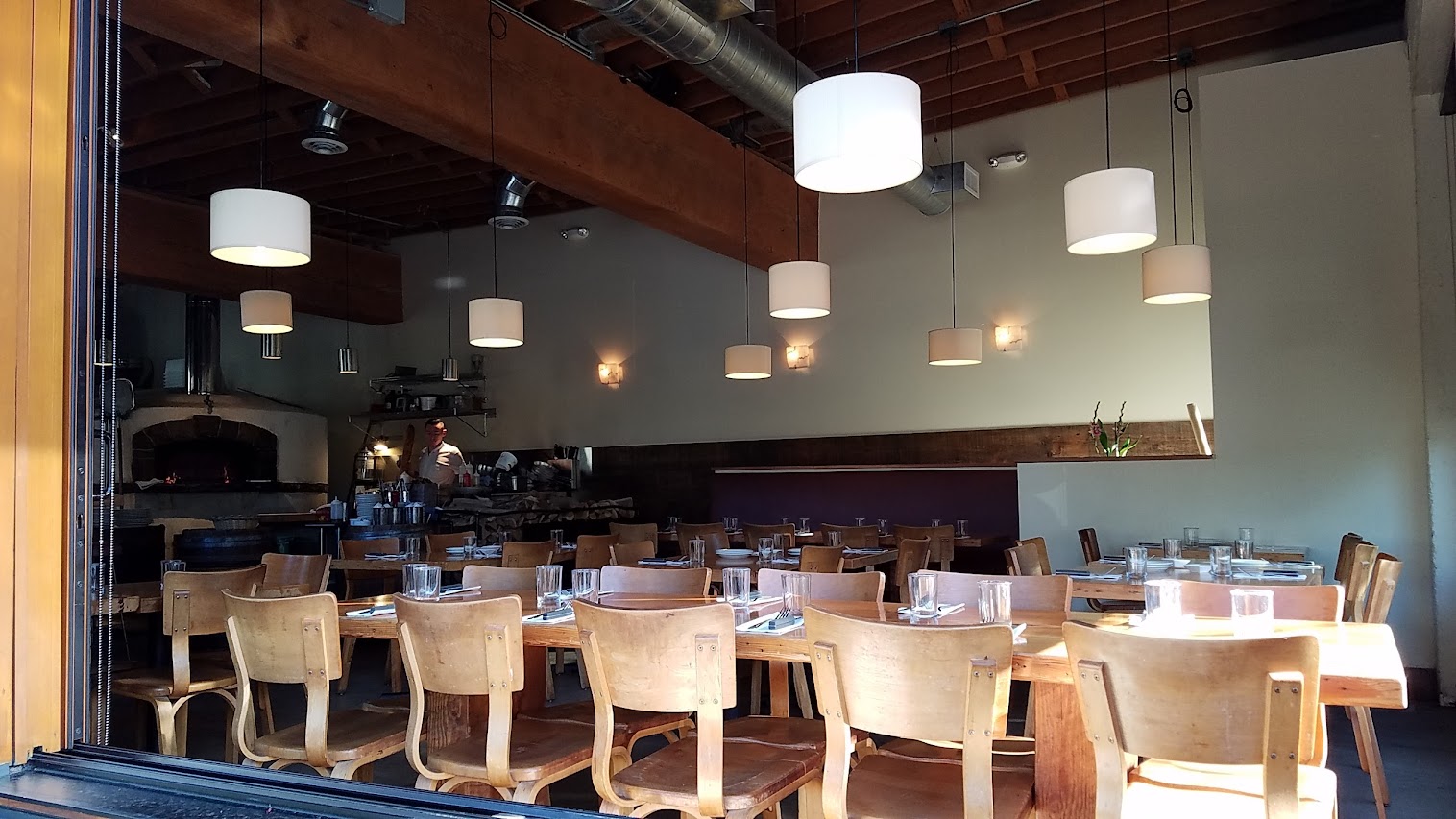 Inside of Ken's Artisan Pizza- The tables and bar were crafted from old growth Douglas fir that was once part of The Big Dipper roller coaster at Jantzen Beach (1923-1970)