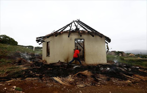 The smouldering remains of Mabuyi Zuma's thatched rondavel which was razed down by fire caused by a lightning was all that remained almost 24hrs after the incident. Image by: THULI DLAMINI