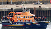 People, believed to be migrants, arrive on a lifeboat before they disembark at Port of Dover, Britain, April 23, 2024.