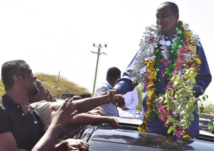 Wajir governor Mohamed Abdi greets his supporters in wajir town moments after taking over office.