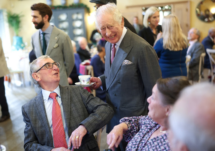 King Charles III's shares a joke with guests as he attends his 75th birthday party hosted by the Prince's Foundation at Highgrove House on November 13, 2023 in Tetbury, England. Guests include local residents who have been nominated by friends and family and individuals and organisations also turning 75 in 2023.