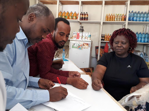 Trade CEC Jubat Adow pens down information from one of the traders in Garissa town. The county government will map out all businesses operating in the region to ease planning and service delivery.