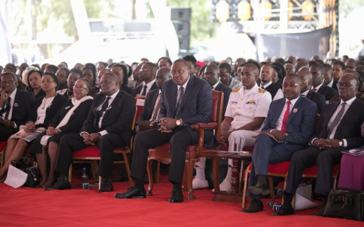 President Uhuru Kenyatta joins family, friends and relatives for the late former Cabinet Minister Charles Wanyoike Rubia for the funeral of deceased at Karigu-ini Primary School grounds in Murang'a County on Monday, December 30, 2019.