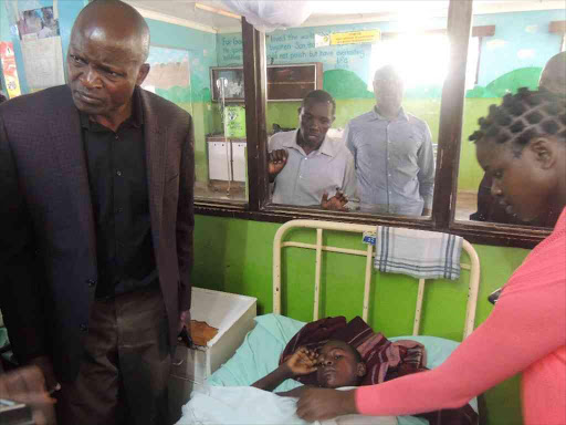 Migori Governor Okoth Obado visits Collins Ochieng, 10, at St Joseph Mission Hospital following attacks on the night of October 27, 2017. /MANUEL ODENY