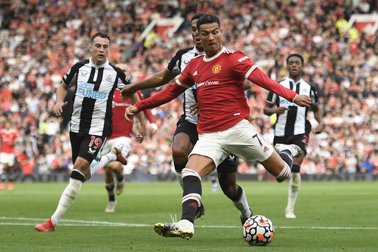 United's Portuguese striker Cristiano Ronaldo prepares to shoot to score their second goal during the English Premier League football match against Newcastle at Old Trafford