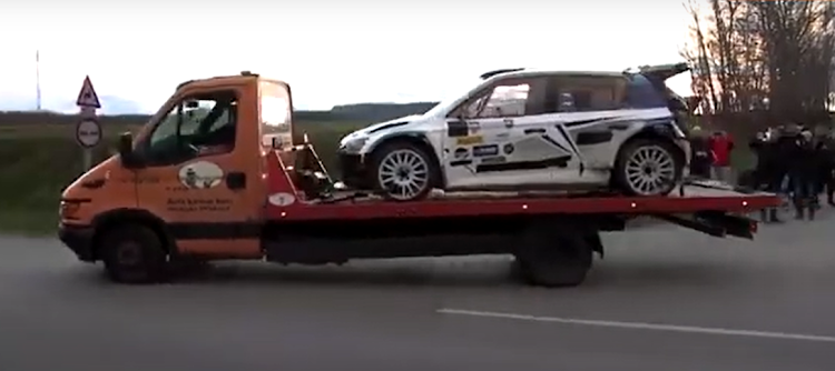 The rally car is taken away after crashing into a crowd in Hungary.