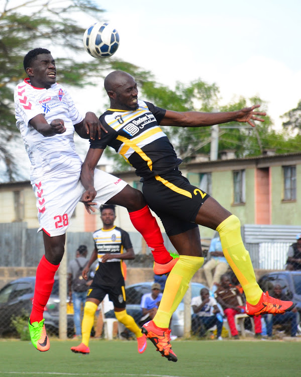 Stephen Owusu of Wazito vies for an aerial ball with Talanta's Gideon Were (L) during a National Super League match at Camp Toyoto