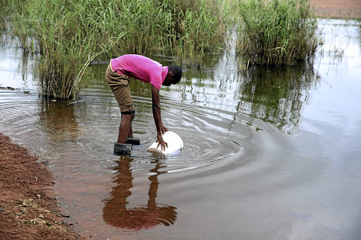 Elias Seloma braves the crocodile-infested Lepelle River near his home in the village of Elandskraal to draw water for his family, because of an unreliable supply from the Sekhukhune district municipality.