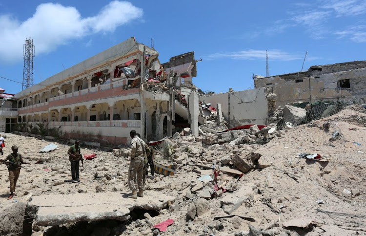 Security forces stand at the SYL hotel that was partly destroyed following a car bomb claimed by Al Shabaab militants outside the president's palace in the Somali capital of Mogadishu, on August 30 2016.