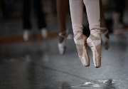 A file photo taken on July 30, 2013 shows dancers practicing at the South African Mzansi Ballet Academy (SAMB) in Johannesburg. It may still have a small following, but one dance company is determined to bring ballet, with its roots in the Italian Renaissance, to urban South Africa. Onstage pirouettes, jetes and turnouts are still very much a foreign concept for most Africans, but the South African Mzansi Ballet wants to change that.