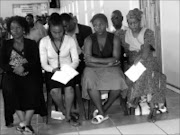 GRIEVING: From left : Abigail, Mercy and Nhlamulo, Khazamula Freddy Baloyi's daughters, at their father's memorial service in Bushbuckridge yesterday. Behind them in a black jacket is their uncle, Baloyi's brother, Sikheto Basil Baloyi. The service was for Baloyi and his colleague, Boy Alfred Dlamini, who killed each other. 04/12/08. Pic. Riot Hlatshwayo. © Sowetan.