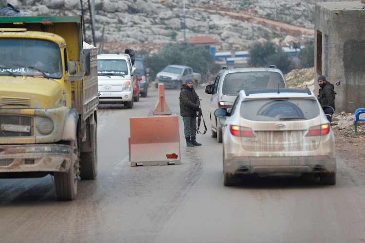 Armed men are seen at a check point in the border town of Al-Bab, near the Syrian-Turkish border, in Idlib province. File photo